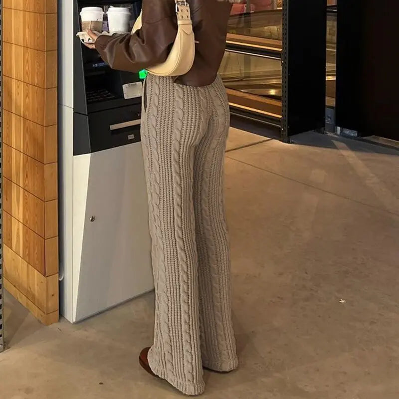 a girl wearing a brown Baggy Pants, and brown leather shoes, in front of ant atm
