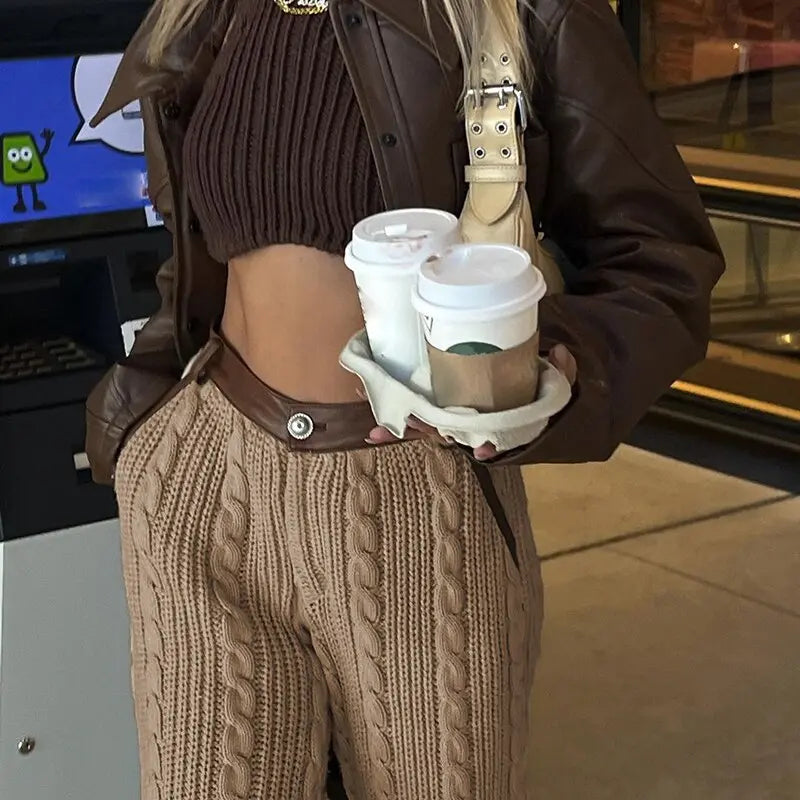 a girl wearing a brown Baggy Pants, and brown leather shoes, and a brown crop top